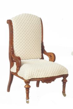 an old fashioned chair with white upholstered fabric