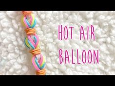 a close up of a string with the words hot air balloon written in pink and orange