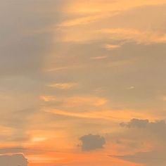 a plane is flying in the sky at sunset with clouds and power lines behind it