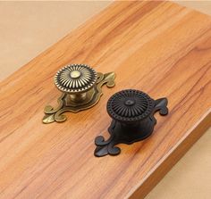 two knobs on the top of a wooden table