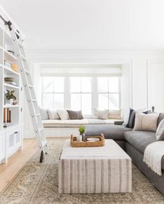 a living room filled with furniture and a ladder