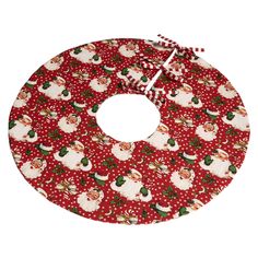 a red and white christmas tree skirt with santa clauss on the front, polka dot background