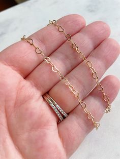 "Gold Heart Bracelet, Heart Chain Bracelet, Gold Heart Jewelry, Heart Chain Jewelry, Valentines Day Gift, Valentines Jewelry, Gift for Her Beautiful and dainty heart chain bracelet. Chain is 14k gold plated (no nickel) with 14k gold filled clasp and jumpring. Heart chain is approx 5mm x 3.5mm...very dainty. Perfect for a simple statement or to layer with other bracelets. Bracelet measures 7\". If you'd like a different length, please leave a note at checkout and I'll be happy to accommodate. Gif Gold Heart Jewelry, Heart Chain Bracelet, Jewelry Valentines Day, Valentine Gifts Jewelry, Gold Heart Bracelet, Bracelet Heart, Jewelry Heart, Heart Chain, Bracelet Chain