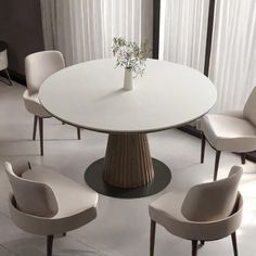 a white table with four chairs around it