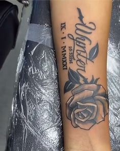 a woman's arm with a rose on it and the words love is forever