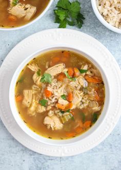 two white bowls filled with chicken and rice soup