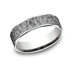 a wedding band that looks like it is made from white gold and has a hammered finish