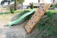 a slide that has been built into the side of a hill with toys on it