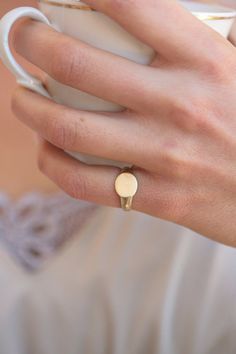 A classic signet ring for women. A dainty 14K yellow gold signet ring. This ring will be especially beautiful as a pinky ring will look great on any finger you choose to wear it. The ring is not hollowed and has a shiny finish, also on the inside. #signetring #goldring #studiounkiya Everyday 14k Yellow Gold Signet Ring, Polished Finish Open Signet Ring For Promise, 14k Gold Tarnish Resistant Signet Ring, Rose Gold Open Signet Ring In Sterling Silver, Rose Gold Sterling Silver Open Signet Ring, 14k Gold Round Signet Ring, Simple 14k Gold Engraved Ring For Anniversary, Oval Dainty Rings With Simple Design, Oval 14k Yellow Gold Midi Rings