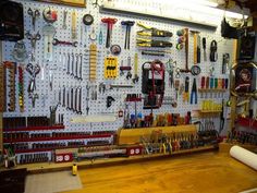 there are many tools hanging on the wall