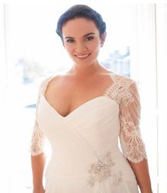 a woman in a wedding dress posing for the camera