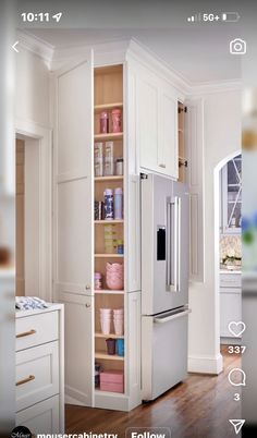 a kitchen with white cabinets and wooden floors