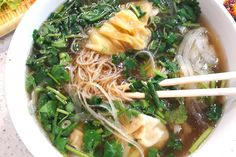 a white bowl filled with noodles and vegetables