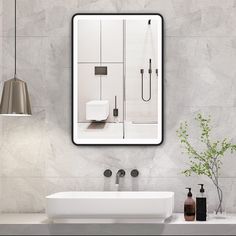 a bathroom with a sink, toilet and mirror on the wall next to a vase