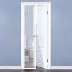 an open white door in a room with blue walls and hardwood flooring on the side