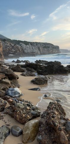 the beach is covered with rocks and water