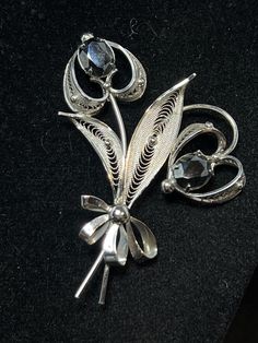 "Sorrento Sterling And Hematite Bouquet Brooch. It is signed Sorrento Sterling. There are no missing or loose stones. It measures: 2\" X 2 5/8\" It comes with a gift box. (Jewelry # 4014) USA Seller!! Estate sale find. We do not Clean or Polish our Estate Jewelry we will leave that to you. We also have Jewelry, Hallmark Ornaments, Dept 56, Vintage Glassware and many other items. We will combine shipping for multiple items if possible. Features: * working clasp Size: Womens 2\" X 2 5/8\" Condition: Pre-Owned Like New" Formal Flower Shaped Hallmarked Brooch, Formal Filigree Flower Brooches, Ornate Flower Brooches For Formal Occasions, Estate Style Silver Jewelry Gift, Estate Style Silver Jewelry For Gifts, Gift Box Jewelry, Bouquet Brooch, Cat Christmas Ornaments, Metalwork Jewelry