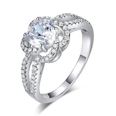 a white gold ring with an oval cut diamond in the center