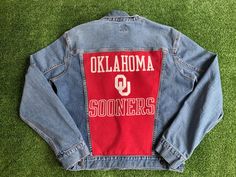 Support your school on and off campus, or stand out at your next tailgate party!  Men's Gap denim jacket customized with school t-shirt sewn on back!  Game Day ready! University of Oklahoma Sooners Jean Jacket  - Gap Jean Jacket - Size: This is a men's size M - nicely distressed look!  Fit is equivalent to a ladies large.  Please see pictures for measurements. - 4 Front pockets Great student gift! Each jacket is custom made and unique, inventory reflects what is available. School Spirit Cotton Outerwear For Game Day, Casual Cotton Denim Jacket For College, Long Sleeve Cotton Denim Jacket For College, Long-sleeved Cotton Denim Jacket For College, Cotton Long Sleeve Denim Jacket For College, Denim Jacket Customized, Jacket Customized, Custom Jean, Custom Jean Jacket