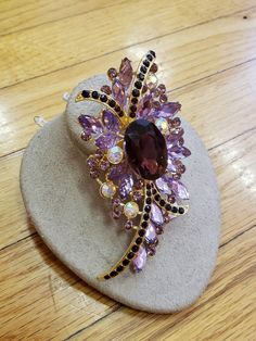 "1950s, 4\" long and 2\" wide, amethyst glass and pink rhinestone ornate brooch ,with gold tone molded back. Condition excellent Price $ 85" Purple Brooch Jewelry For Evening, Purple Amethyst Brooches For Wedding, Elegant Purple Rhinestone Brooches, Purple Rhinestone Party Brooches, Jewelry Board, Jewelry Boards, Button Jewelry, Womens Clothes, Amethyst Jewelry