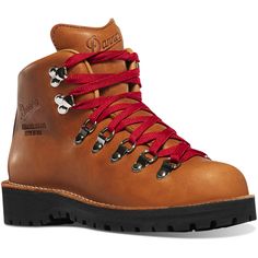 a pair of brown boots with red laces on the side and black soles