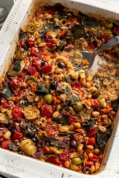 a casserole dish filled with lots of different types of vegetables and nuts in it