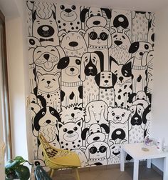 the wall is decorated with black and white doodle dogs on it's side