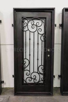 two black doors with wrought iron designs on the front and back sides, side by side