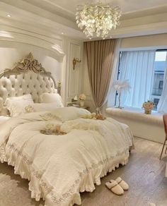 a bedroom with white furniture and chandelier