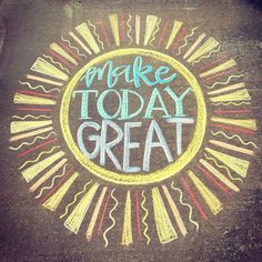 the words make today great written in chalk on asphalt with sunbursts around it