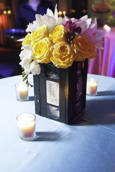 flowers and candles are on the table in front of an empty card box with cards