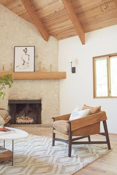 a living room filled with furniture and a fire place in the middle of a room