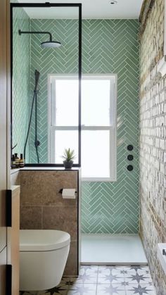 a bathroom with green and white tiles on the walls