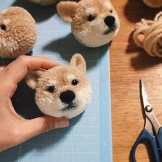 a person holding a stuffed animal in front of some other stuffed animals on a table