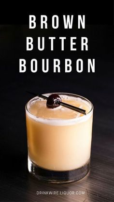 the brown butter bourbon is served in a glass with an olive garnish on top