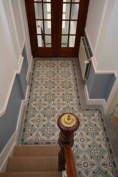 an overhead view of a stair case with blue walls and floor tiles on the ground