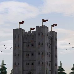 a large castle with two flags on top and birds flying in the sky above it