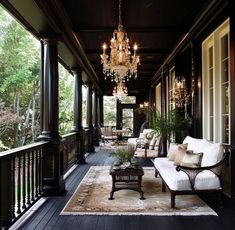 an elegant porch with chandelier and couches