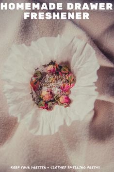 a white paper plate sitting on top of a bed covered in pink and green flowers