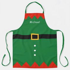 a green apron with a red and black santa hat on it's chest that says, michael