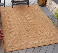 an outdoor area with a chair and rug