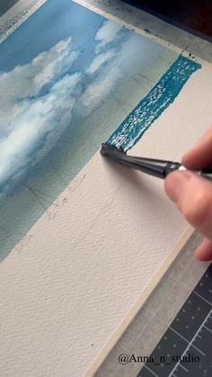 someone is painting an image with watercolors on paper