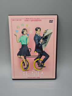 a dvd cover with an image of two people on a bicycle