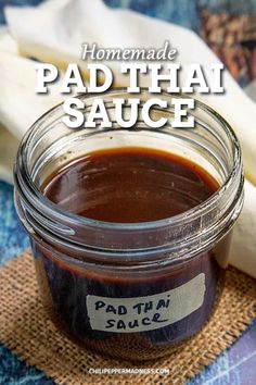 homemade pad thai sauce in a glass jar on a burlocked table cloth