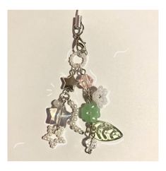 a key chain with charms and beads hanging from it's side on a white surface