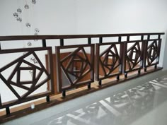 a wooden balcony railing with glass balls hanging from it