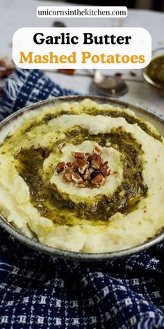 garlic butter mashed potatoes in a bowl with pesto sauce and almonds on top