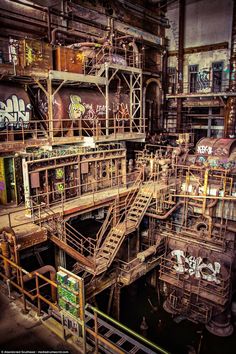 an old factory with lots of graffiti on the walls