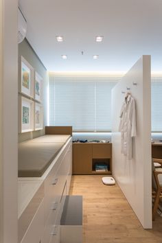 this is an image of a modern kitchen with white cabinets and counter tops, along with wooden flooring