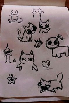 a piece of paper that has some drawings on it with cats and dogs drawn on it